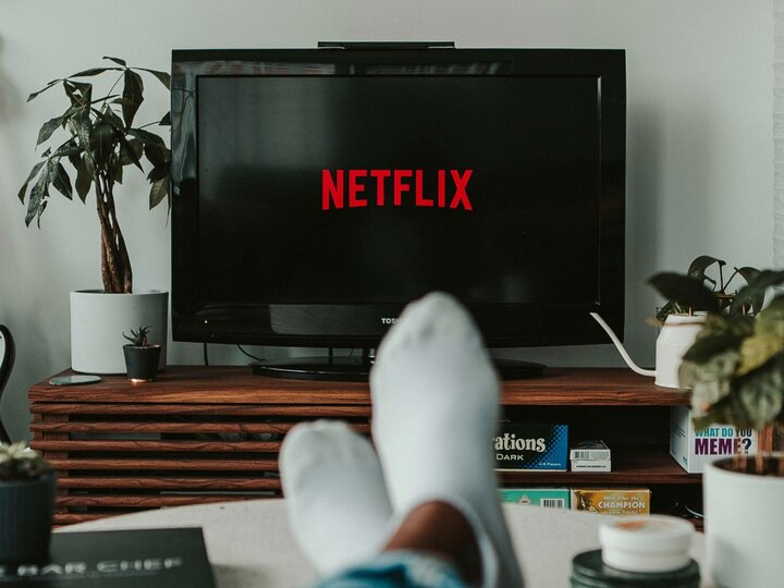 Netflix loading screen with someone with their feet on a table in the foreground