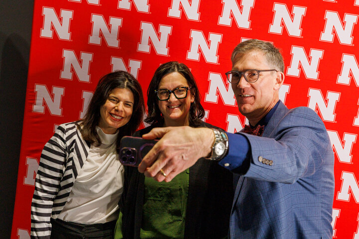 Dean Nick Pace takes a selfie with two award winners.